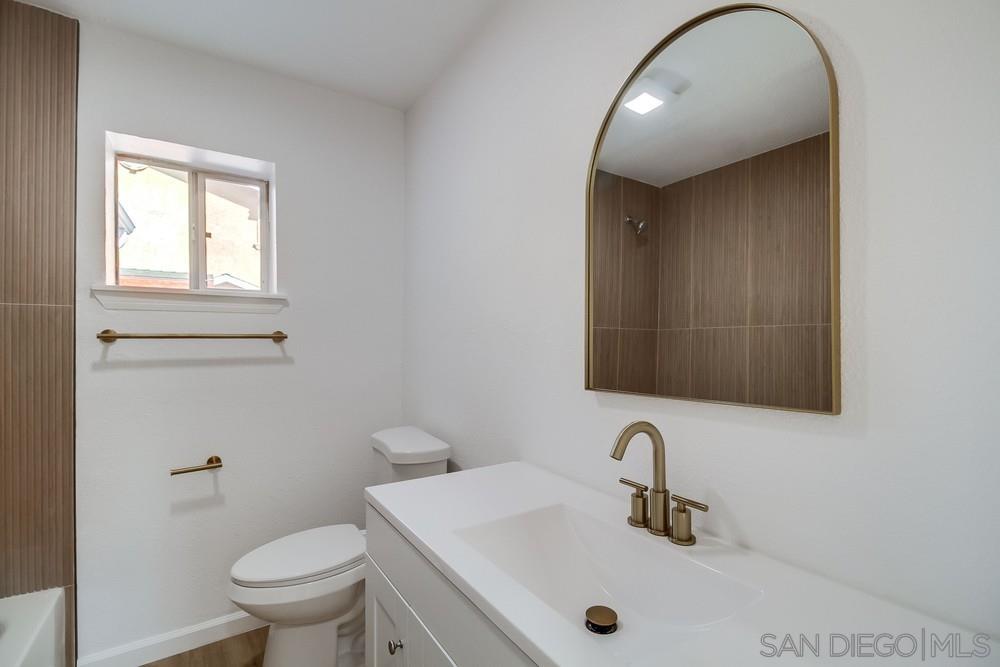 796 West Washington Avenue El Cajon, CA 92020 - Photo 13 of 71 a bathroom with a sink a toilet and mirror