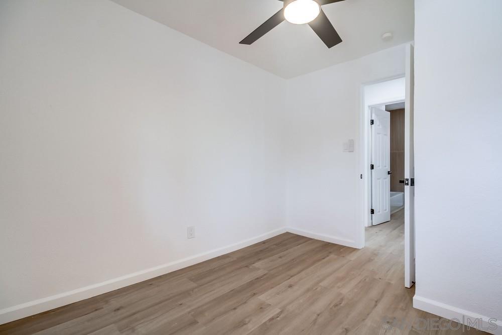 796 West Washington Avenue El Cajon, CA 92020 - Photo 17 of 71 an empty room with a ceiling fan and wooden floor