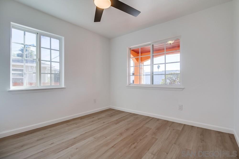 796 West Washington Avenue El Cajon, CA 92020 - Photo 21 of 71 an empty room with wooden floor fan and windows
