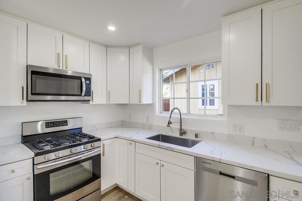 796 West Washington Avenue El Cajon, CA 92020 - Photo 39 of 71 a kitchen with white cabinets and appliances