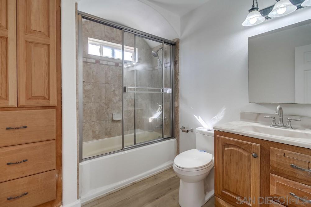 796 West Washington Avenue El Cajon, CA 92020 - Photo 48 of 71 a bathroom with a granite countertop toilet a sink and bathtub