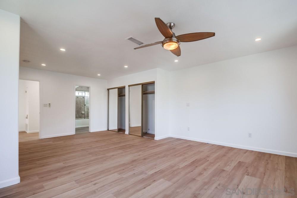 796 West Washington Avenue El Cajon, CA 92020 - Photo 50 of 71 an empty room with wooden floor a ceiling fan and windows