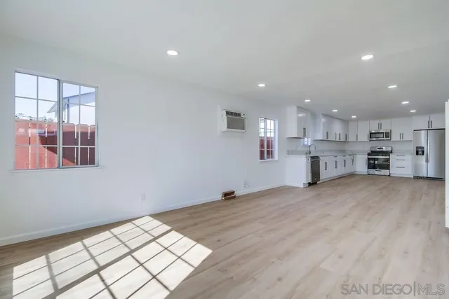 a kitchen with granite countertop white cabinets and stainless steel appliances