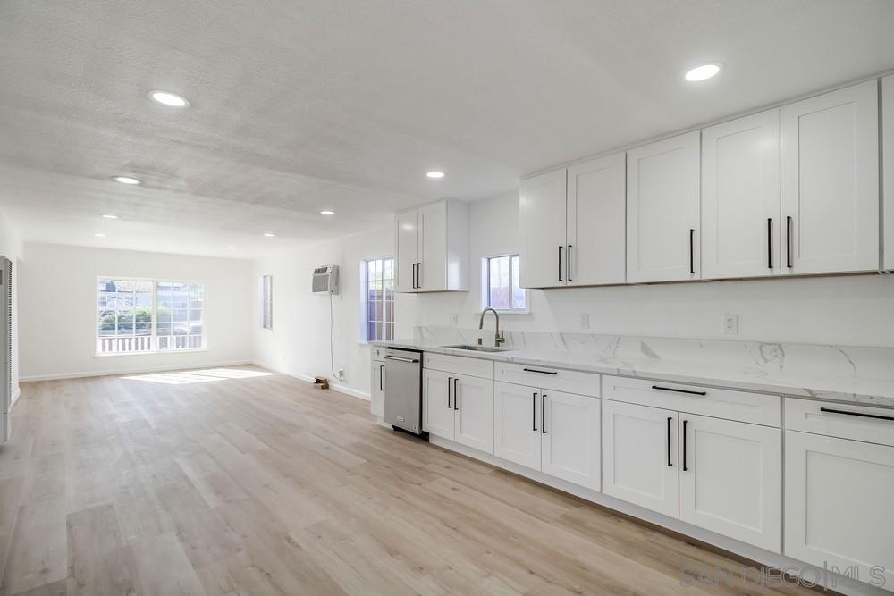 796 West Washington Avenue El Cajon, CA 92020 - Photo 10 of 71 a kitchen with granite countertop white cabinets and white appliances
