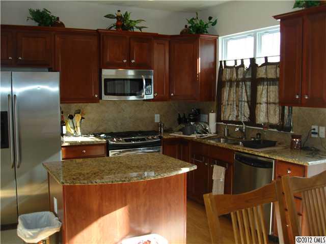 566 6th Baxter Crossing Fort Mill, SC 29708 - Photo 3 of 7 a kitchen with a sink a stove and a refrigerator