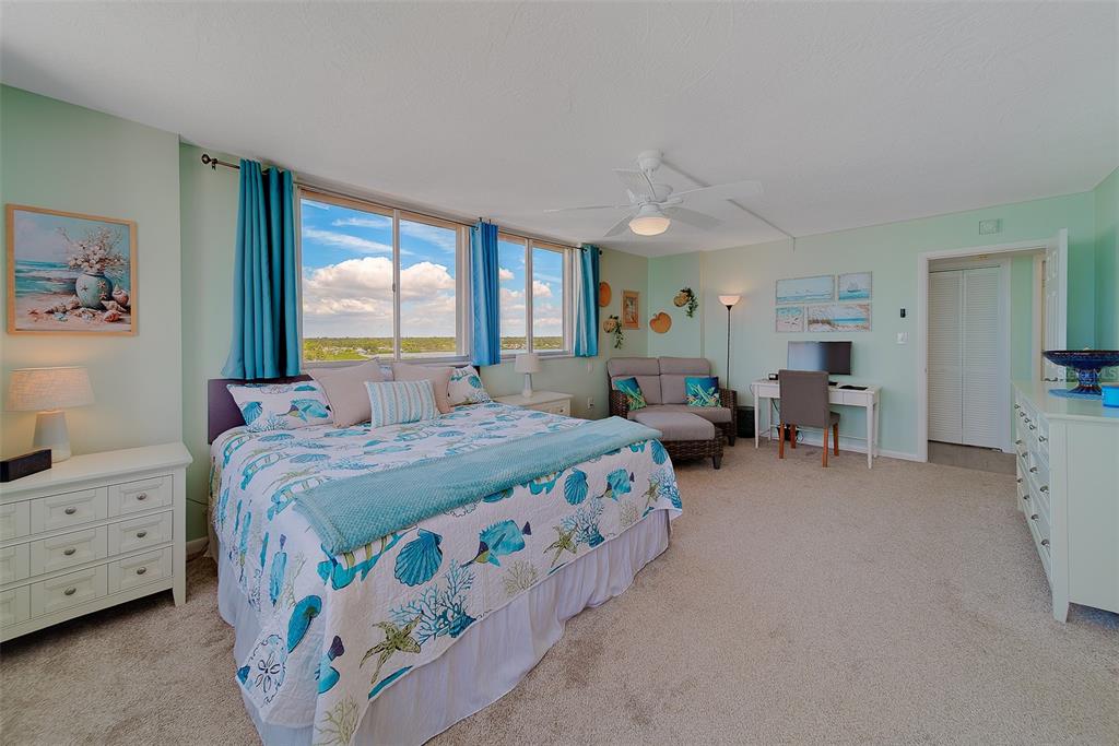 17920 Gulf Boulevard, Unit 1205 Redington Shores, FL 33708 - Photo 21 of 67 a bedroom with bed and large windows