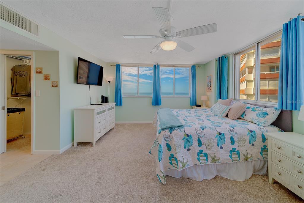 17920 Gulf Boulevard, Unit 1205 Redington Shores, FL 33708 - Photo 25 of 67 a bedroom with a bed and a flat tv screen on dresser