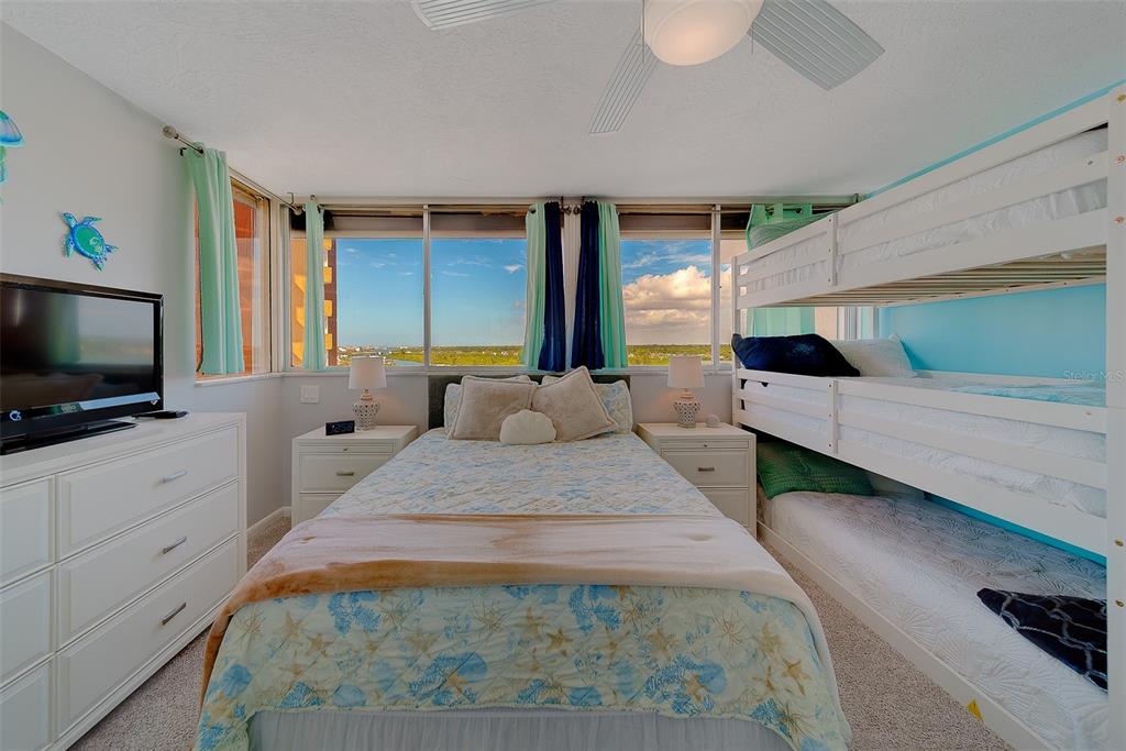 17920 Gulf Boulevard, Unit 1205 Redington Shores, FL 33708 - Photo 33 of 67 a large bedroom with bed tv and window