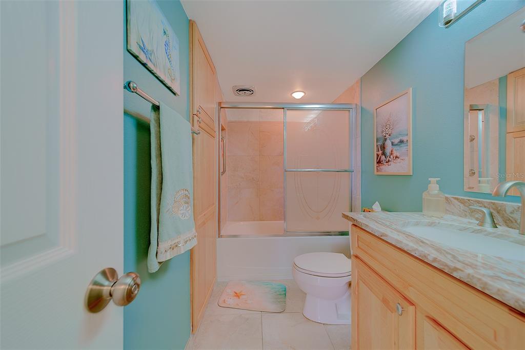 17920 Gulf Boulevard, Unit 1205 Redington Shores, FL 33708 - Photo 36 of 67 a bathroom with a granite countertop sink a toilet and shower