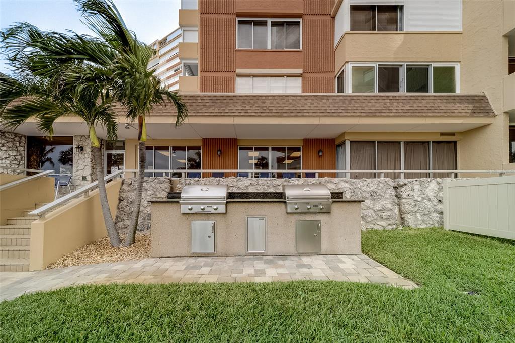 17920 Gulf Boulevard, Unit 1205 Redington Shores, FL 33708 - Photo 48 of 67 a front view of a house with garage and yard