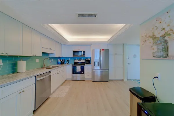 a kitchen with stainless steel appliances a refrigerator and a sink