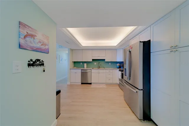a kitchen with cabinets appliances and a sink
