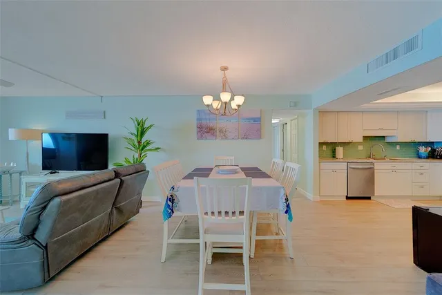 a view of a dining room with furniture and chandelier