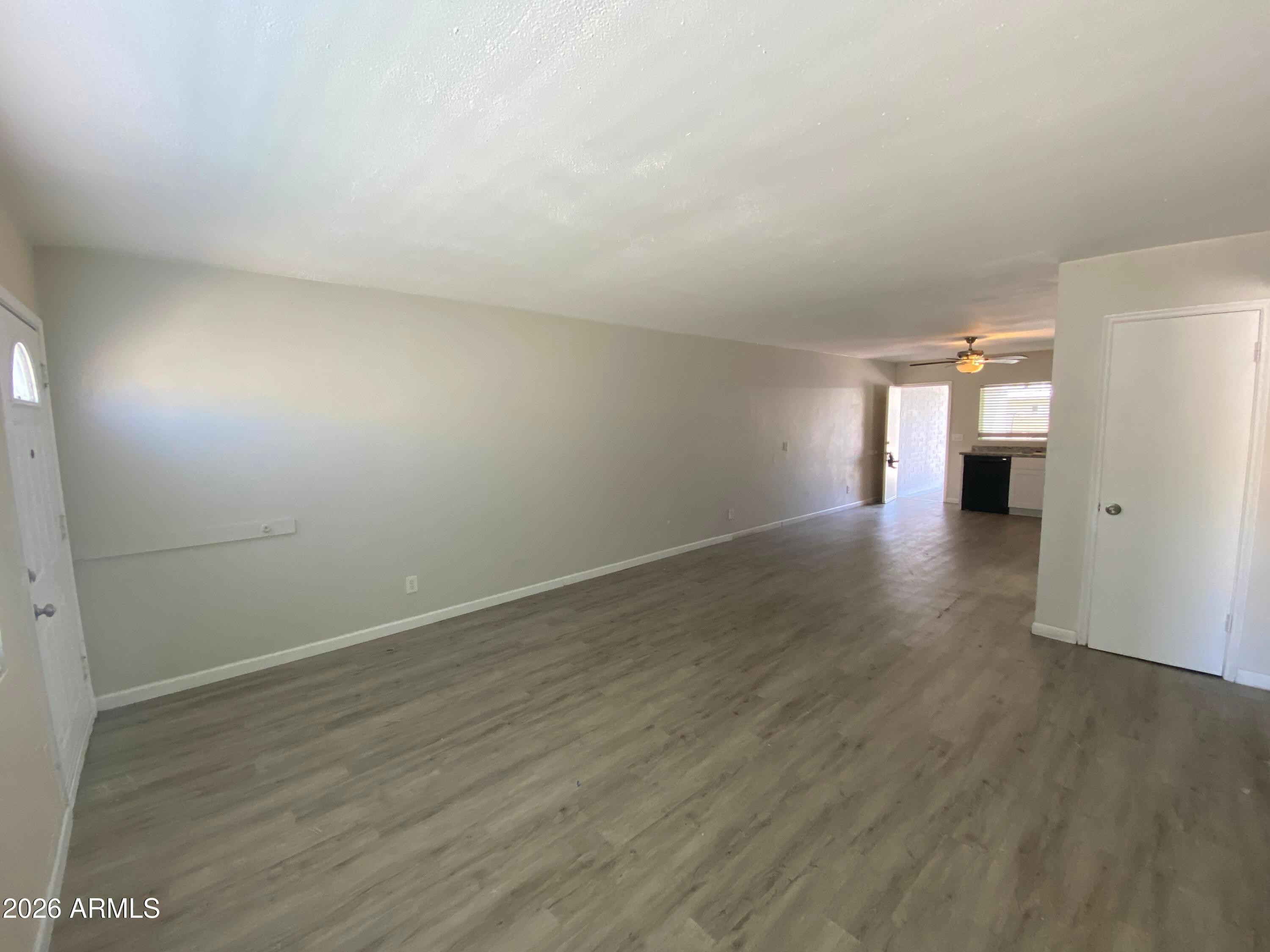 1124 North 27th Street, Unit 4 Phoenix, AZ 85008 - Photo 2 of 9 wooden floor in an empty room with a window