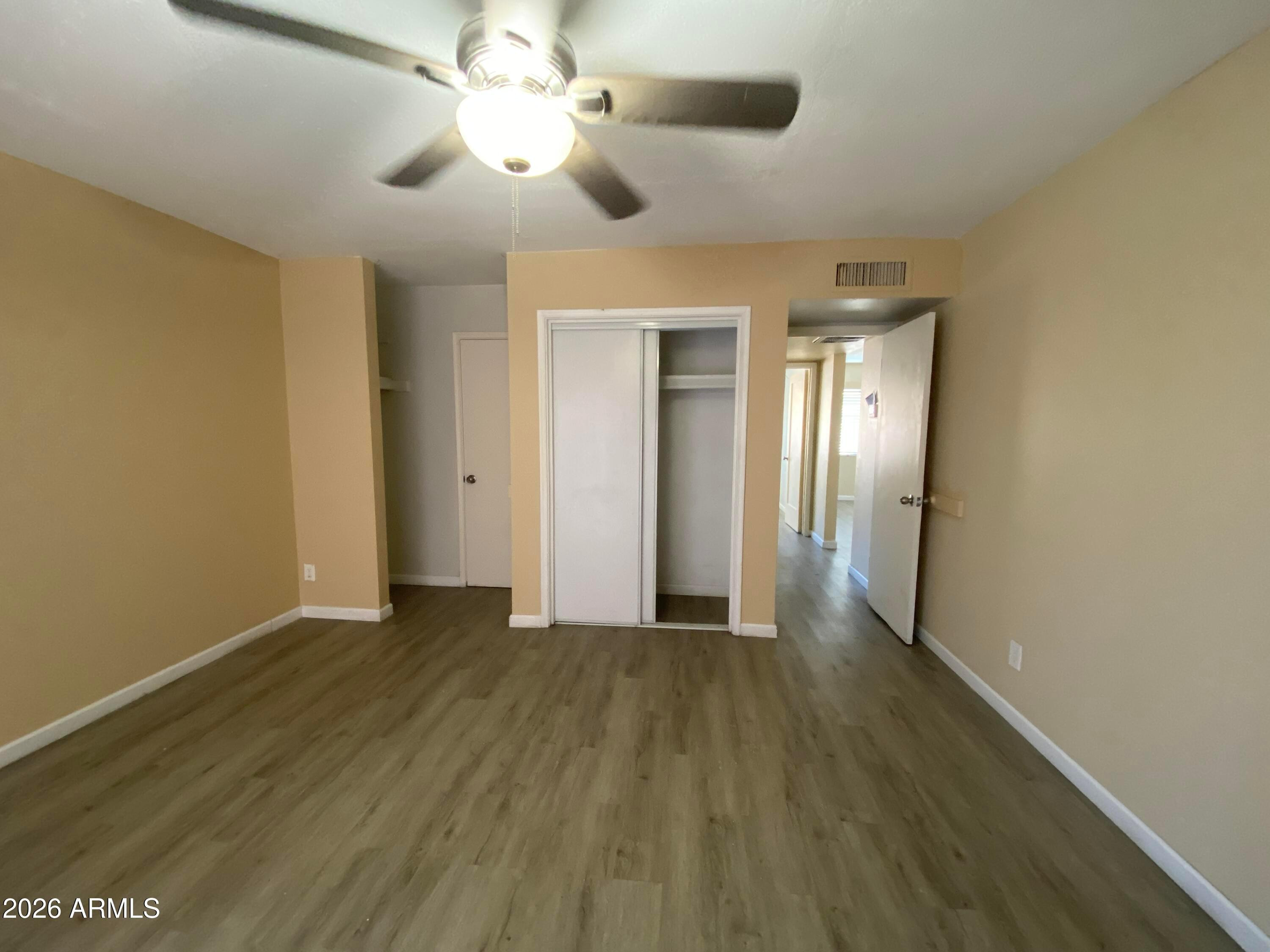1124 North 27th Street, Unit 4 Phoenix, AZ 85008 - Photo 9 of 9 wooden floor in an empty room with a window