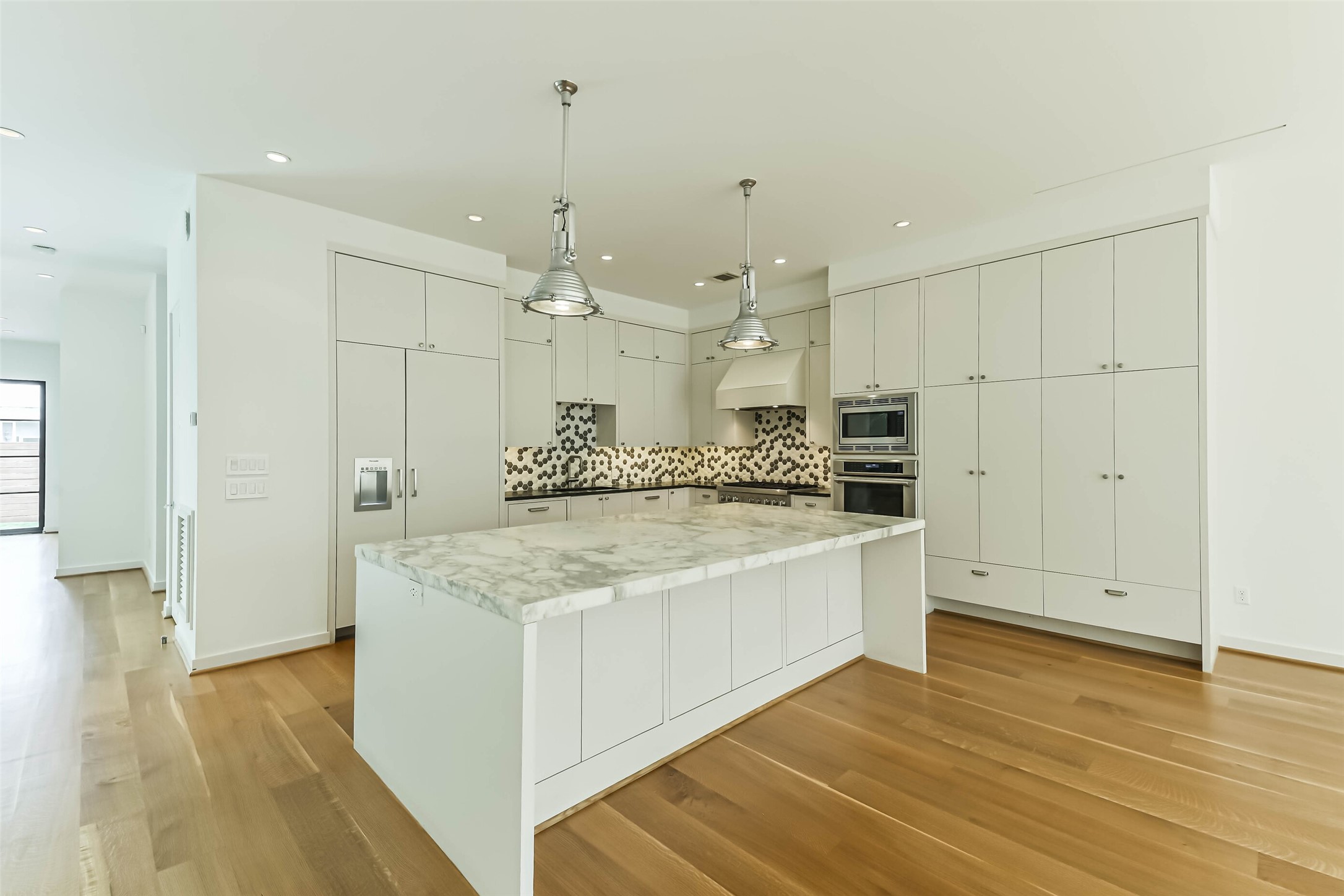 815 Alexander Street Houston, TX 77007 - Photo 14 of 49 Chef's kitchen featuring an oversized Carrara marble island and custom cabinetry.