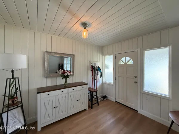 a view of a room with a mirror and furniture