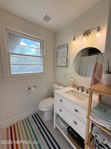 a white toilet sitting next to a bathroom sink