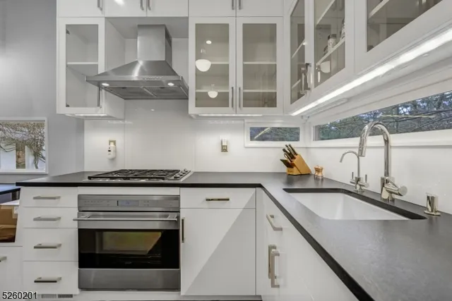 a view of a room that has a window and wooden floor