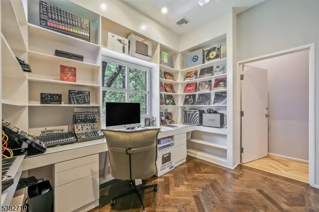 a bathroom with a toilet a sink a mirror a window and shower