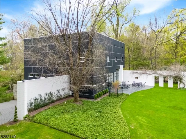 a view of house with a backyard