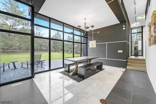 a view of an empty room with stairs and wooden floor