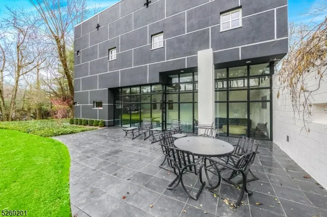 a view of a patio with table and chairs and potted plants