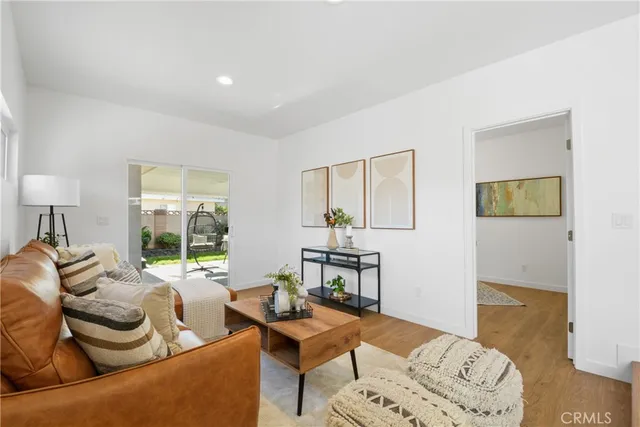 a bedroom with furniture and a wooden floor