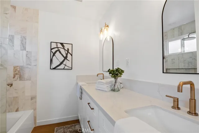 a front view of a house with a garden and yard