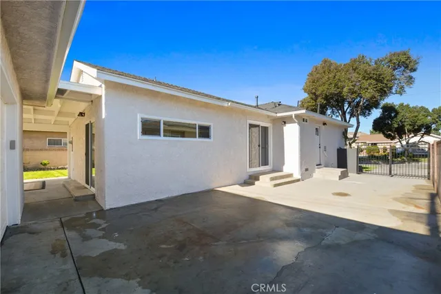 a view of a patio with a table chairs and a garden