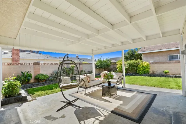 a view of a patio with table and chairs potted plants