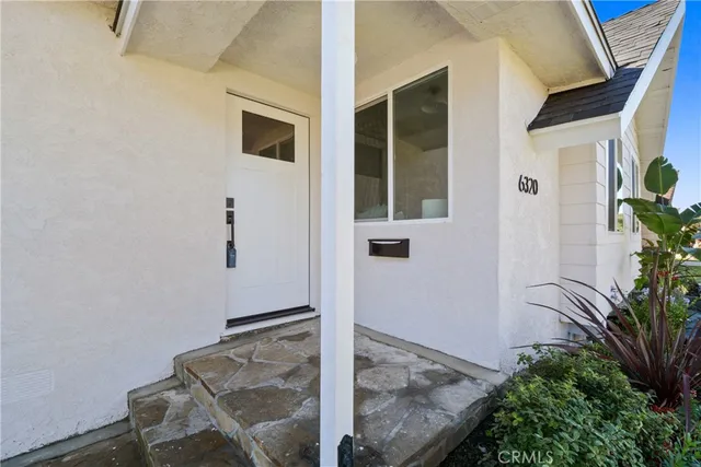 a backyard with table and potted plant