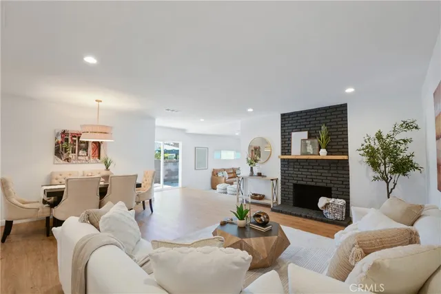 a living room with furniture fireplace and window
