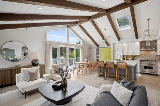 a living room with furniture potted plant and a large window
