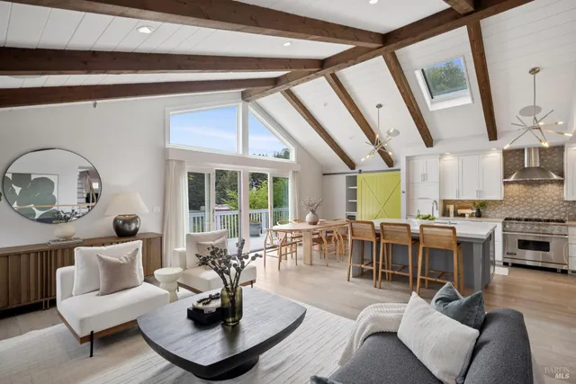 a living room with furniture potted plant and a large window