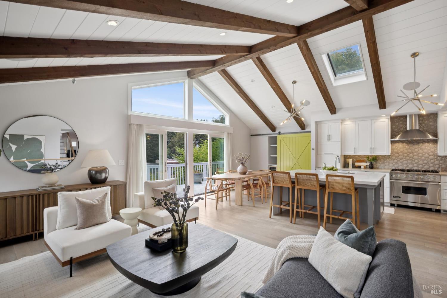 a living room with furniture potted plant and a large window