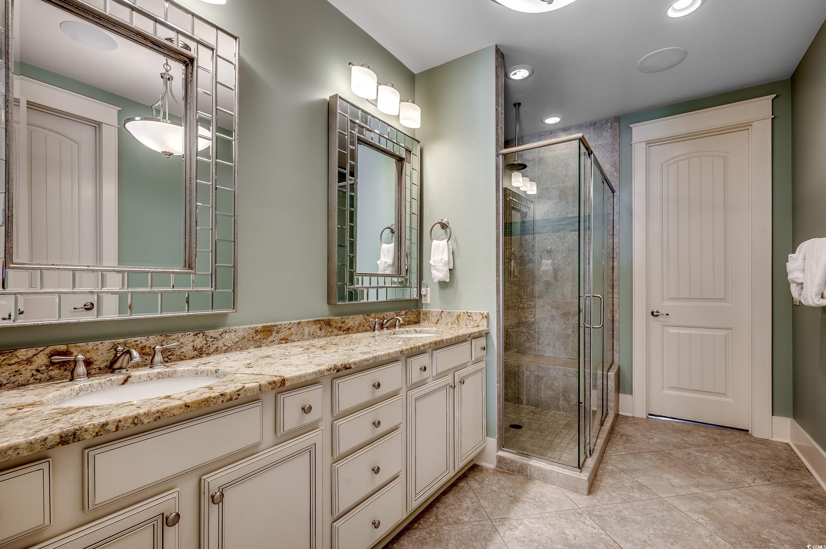 4964 Salt Creek Court North Myrtle Beach, SC 29582 - Photo 12 of 35 Bathroom with tile patterned floors, a sink, double vanity, and a stall shower