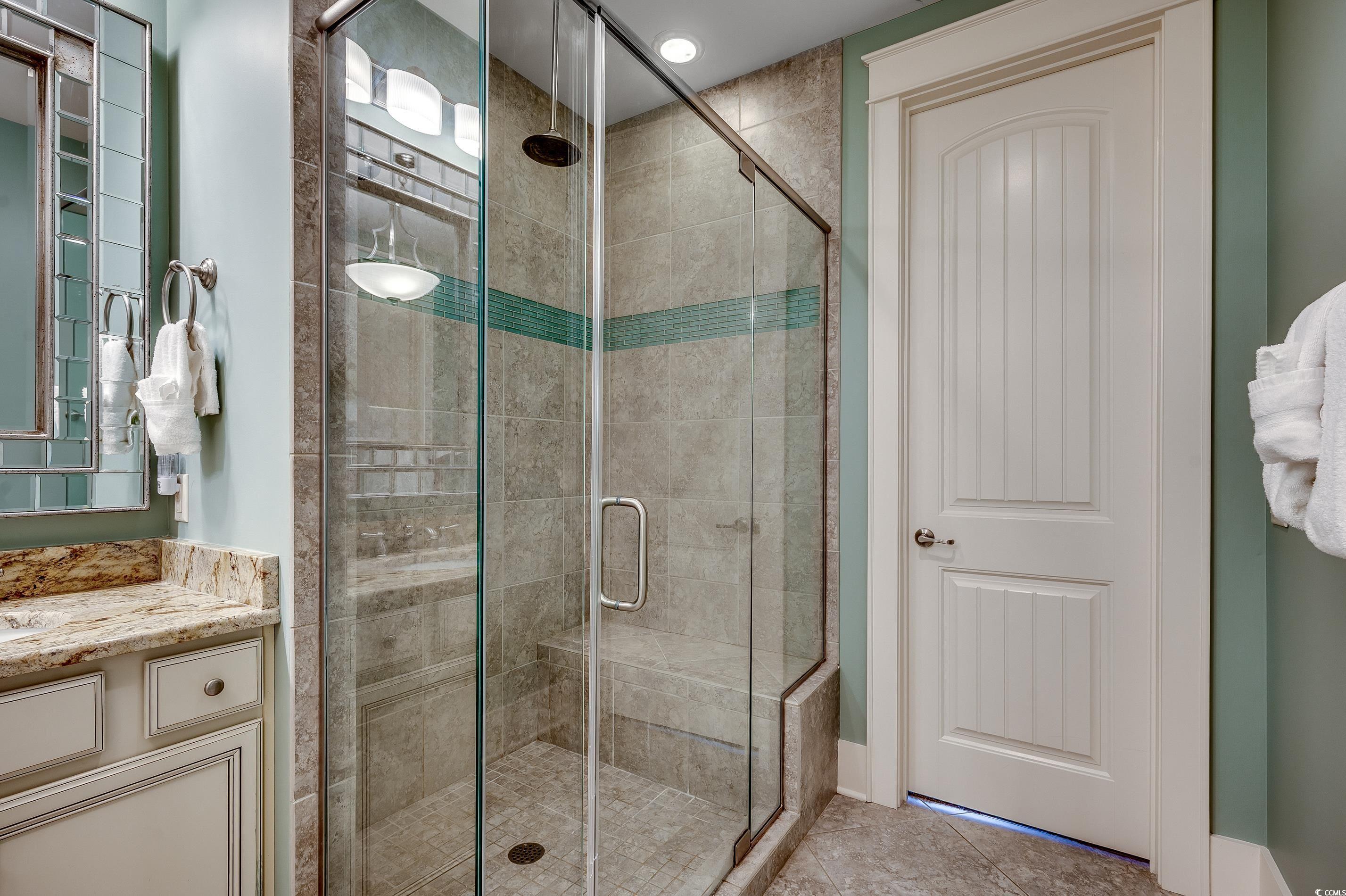 4964 Salt Creek Court North Myrtle Beach, SC 29582 - Photo 13 of 35 Full bathroom featuring vanity, tile patterned flooring, and a shower stall