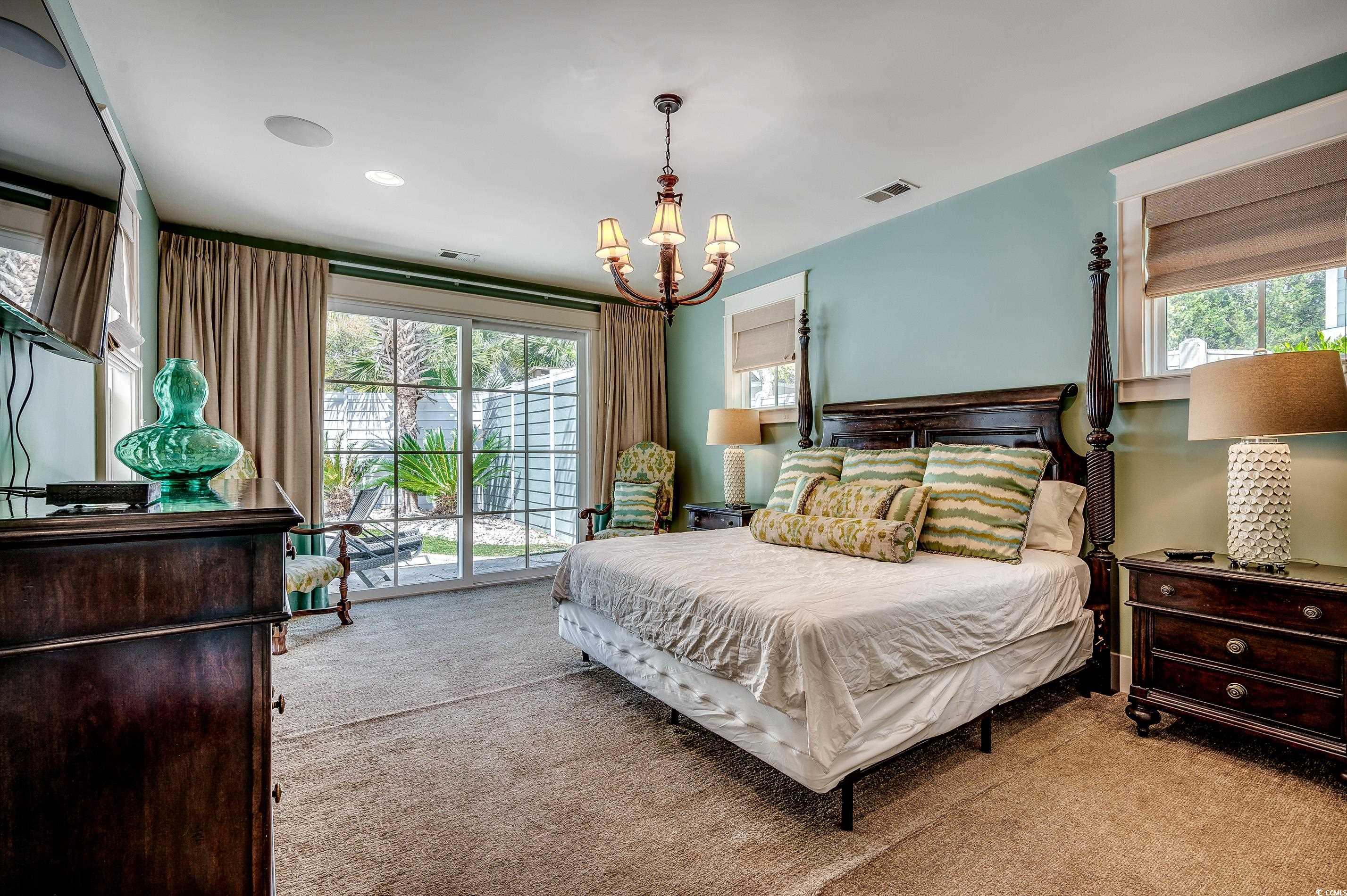 4964 Salt Creek Court North Myrtle Beach, SC 29582 - Photo 15 of 35 Carpeted bedroom featuring multiple windows, access to exterior, a notable chandelier, and visible vents
