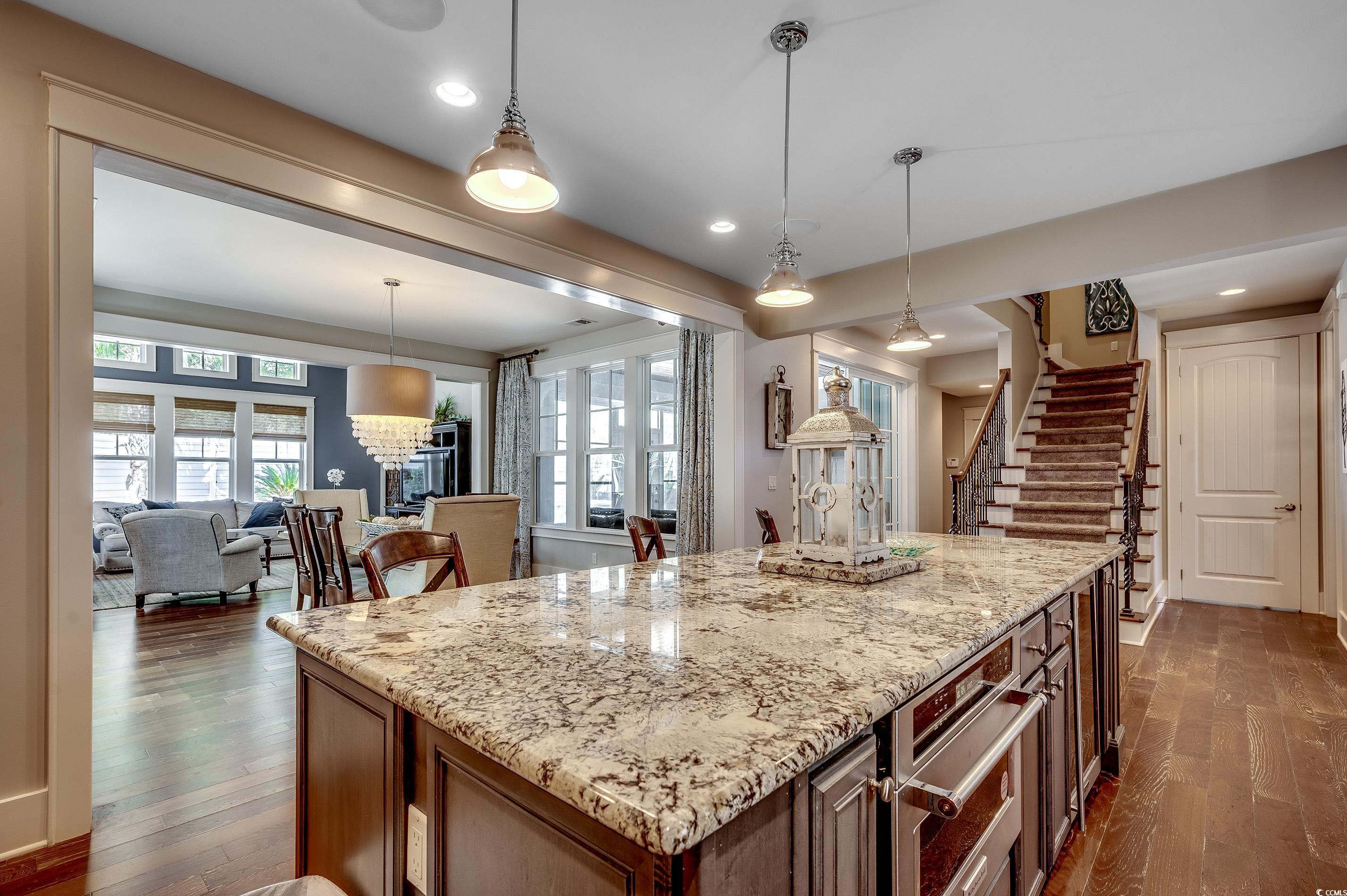 4964 Salt Creek Court North Myrtle Beach, SC 29582 - Photo 21 of 35 Kitchen featuring plenty of natural light, dark wood-style floors, and light stone counters