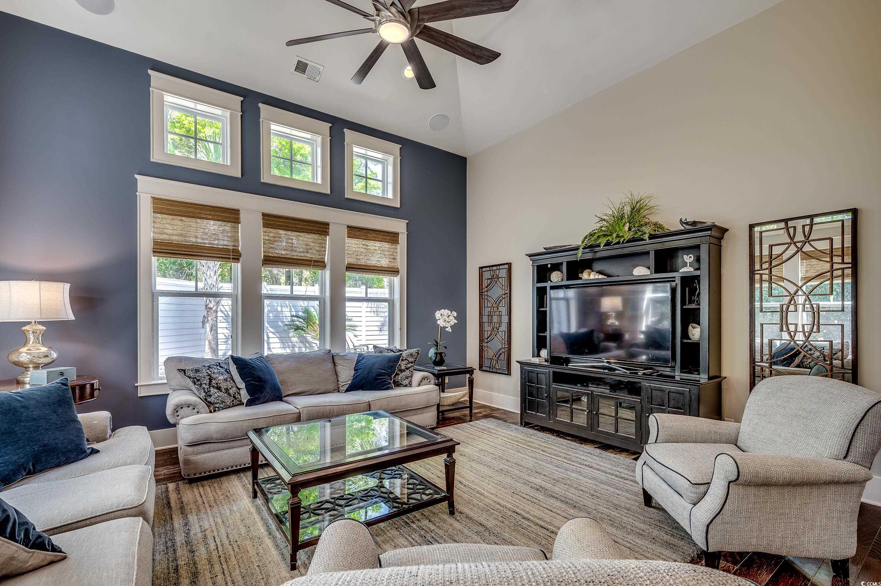 4964 Salt Creek Court North Myrtle Beach, SC 29582 - Photo 23 of 35 Living area featuring wood finished floors, visible vents, baseboards, high vaulted ceiling, and ceiling fan