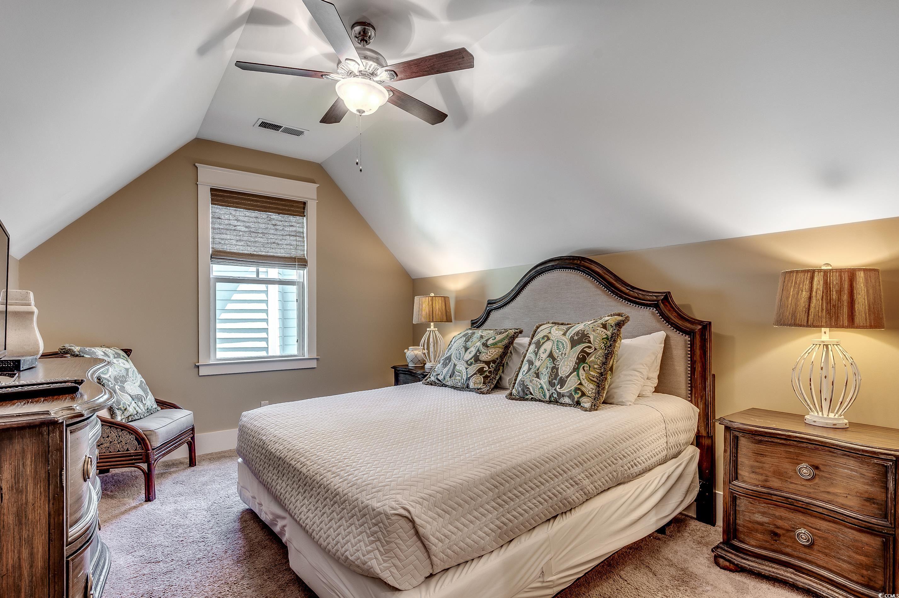 4964 Salt Creek Court North Myrtle Beach, SC 29582 - Photo 3 of 35 Carpeted bedroom featuring ceiling fan, lofted ceiling, and visible vents