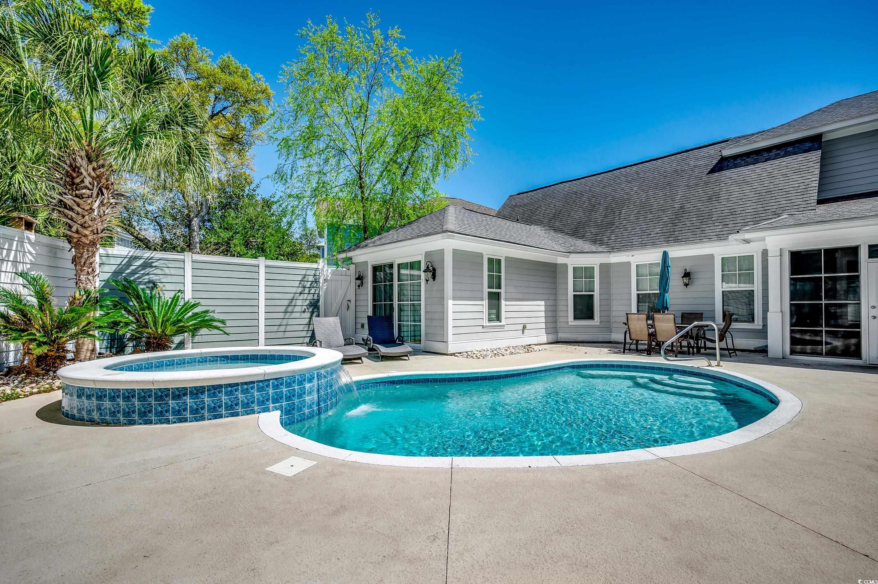 4964 Salt Creek Court North Myrtle Beach, SC 29582 - Photo 32 of 35 View of swimming pool with central air condition unit, fence, a patio area, and a pool with connected hot tub