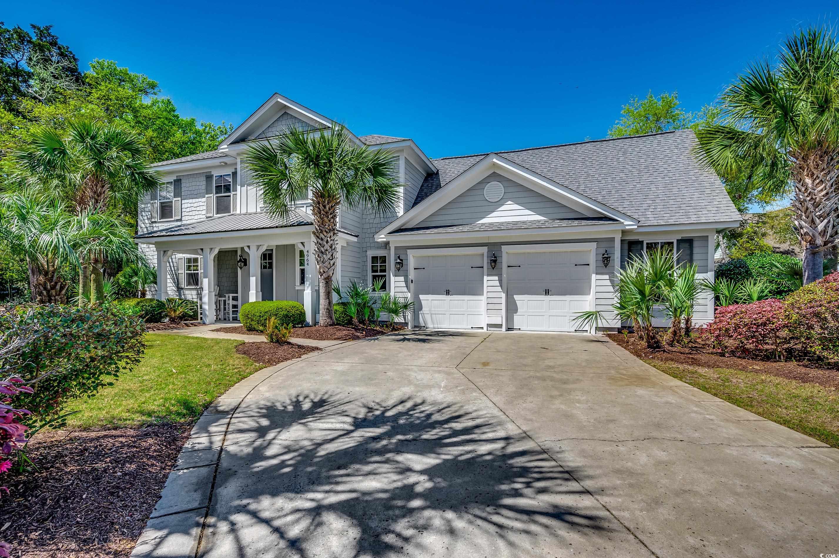 4964 Salt Creek Court North Myrtle Beach, SC 29582 - Photo 35 of 35 View of front facade featuring a porch, concrete driveway, roof with shingles, and a garage