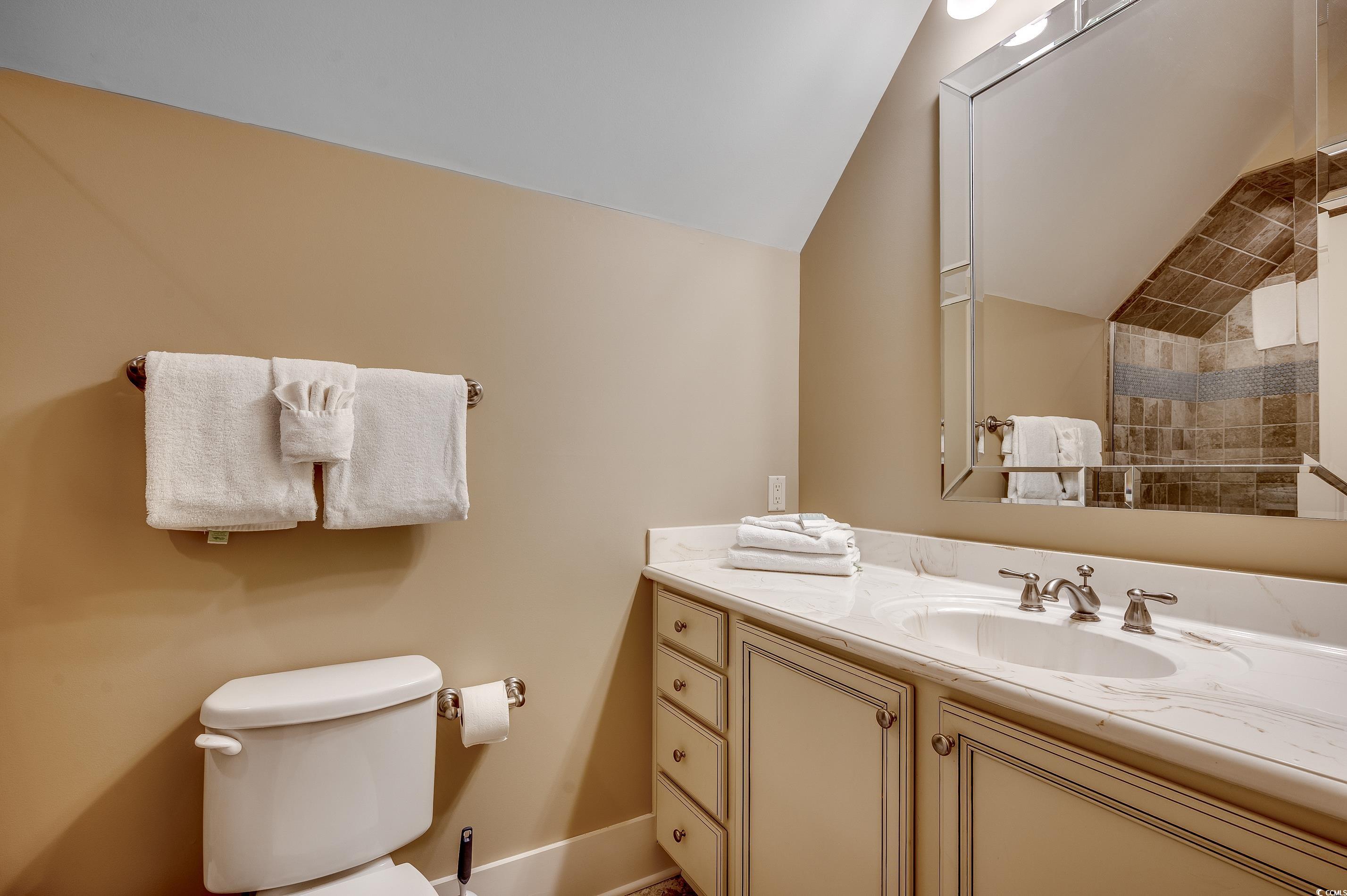 4964 Salt Creek Court North Myrtle Beach, SC 29582 - Photo 4 of 35 Bathroom with vaulted ceiling, vanity, and toilet