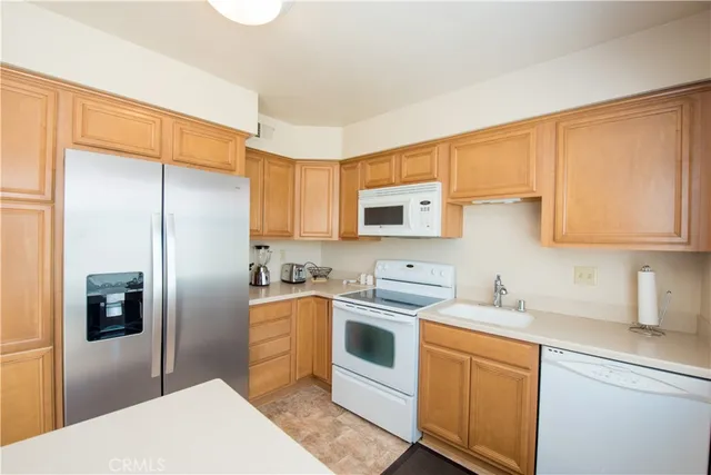 a kitchen with stainless steel appliances granite countertop a refrigerator sink and microwave