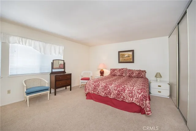 a bedroom with a bed and a view of chair