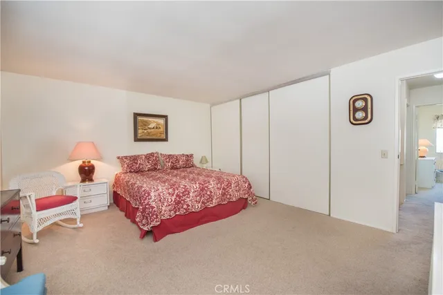 a bedroom with a bed and a painting on the wall