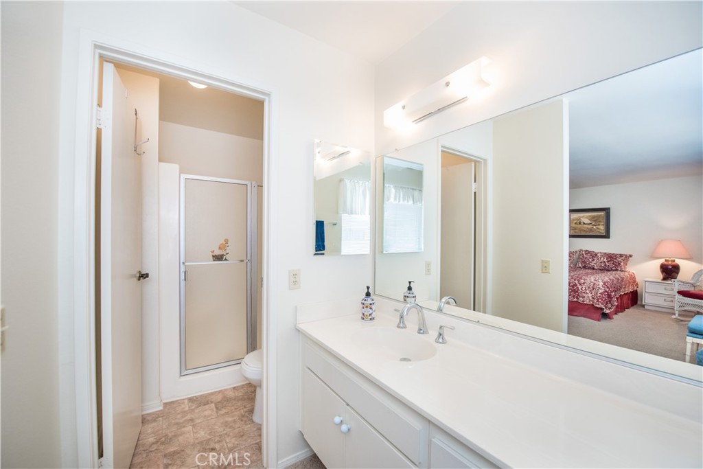 6087 Montecito Circle, Unit 4 Palm Springs, CA 92264 - Photo 21 of 45 a en suite bathroom with a double vanity sink mirror and double