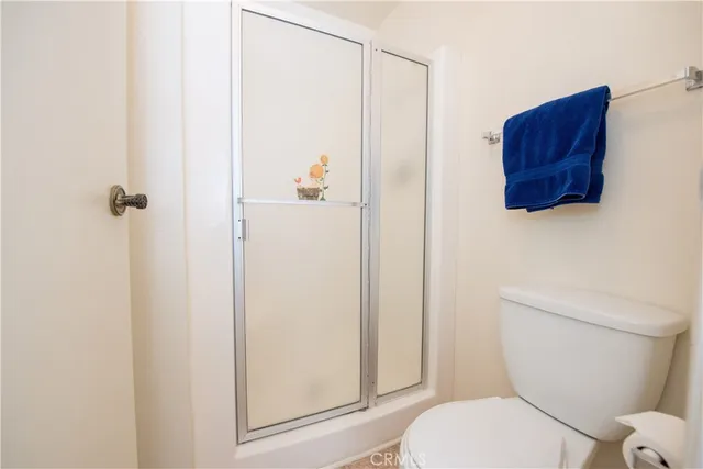 a white toilet sitting next to a bathroom sink